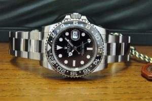 The stainless steel copy Rolex GMT-Master II 116710LN watches have black dials.